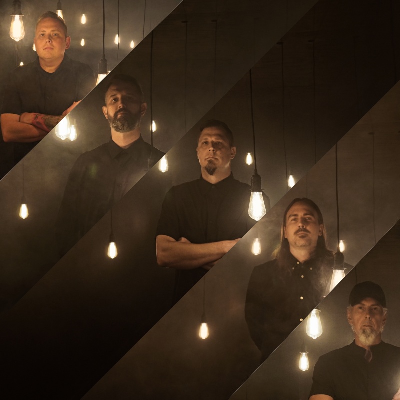 Band portrait under hanging Edison bulbs