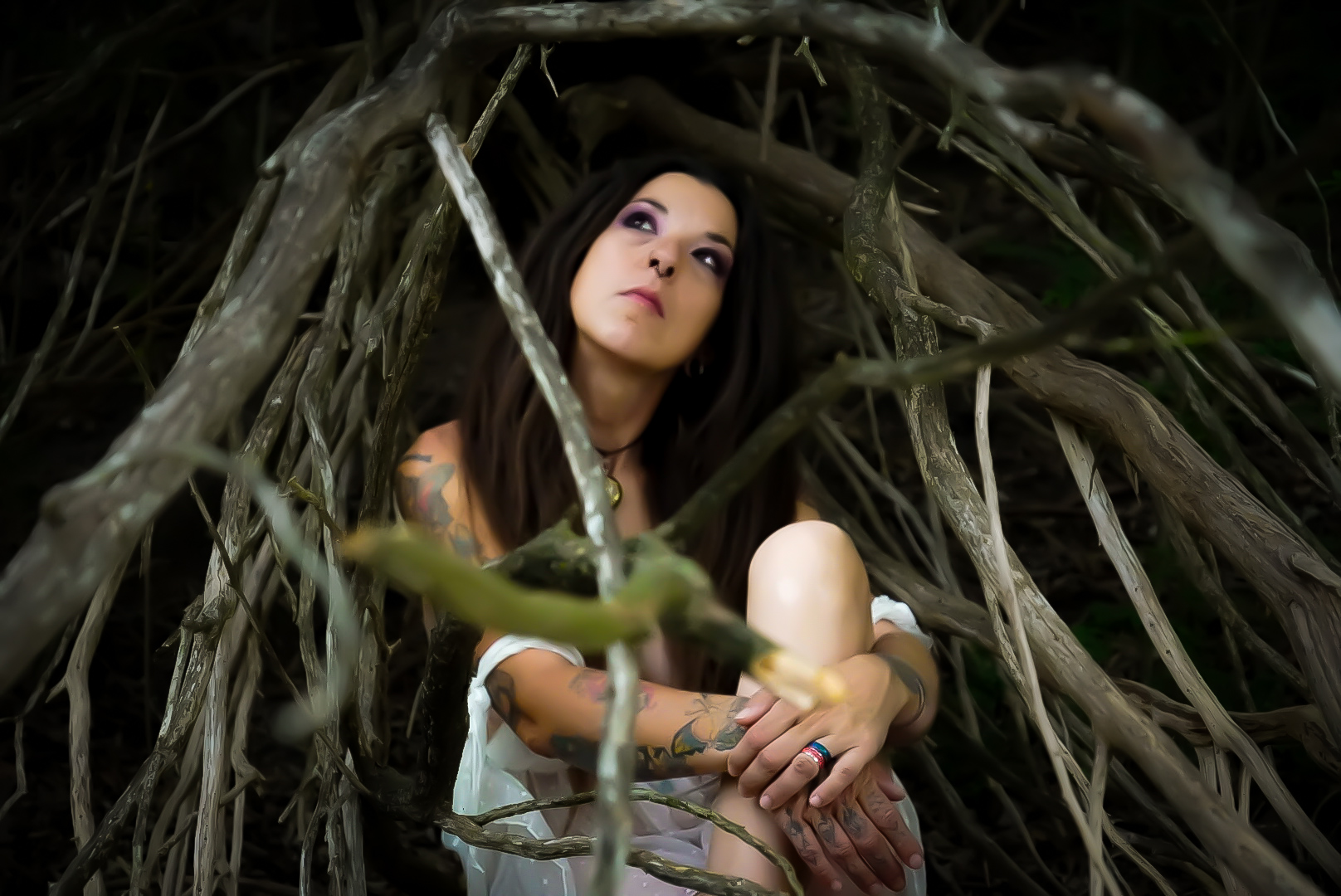 Moody portrait framed by tree branches