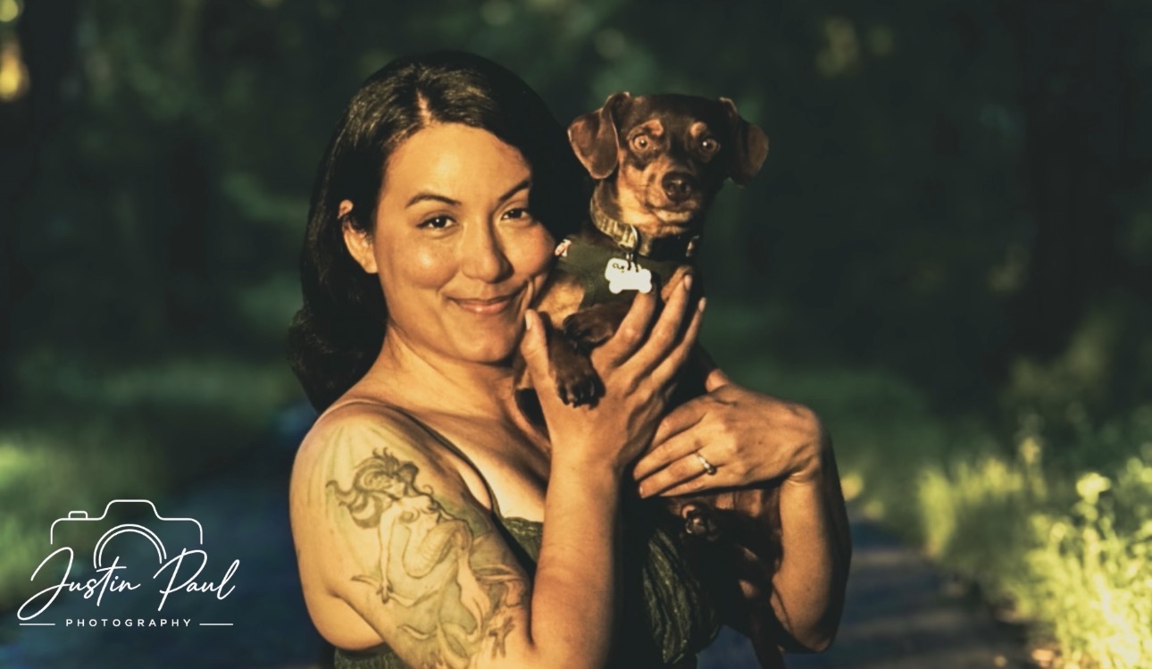Woman holding a small dog with Justin Paul Photography watermark