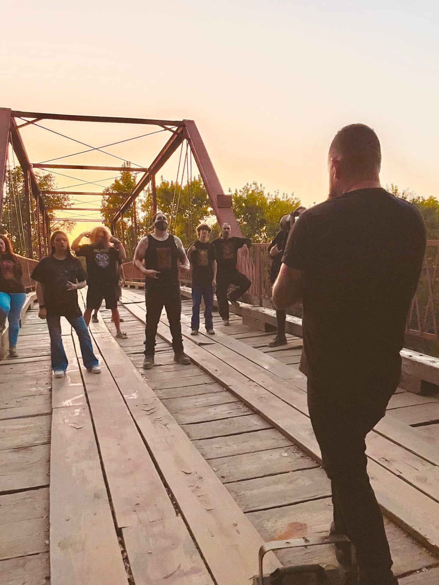 Filming a metal band on a sunset bridge shoot